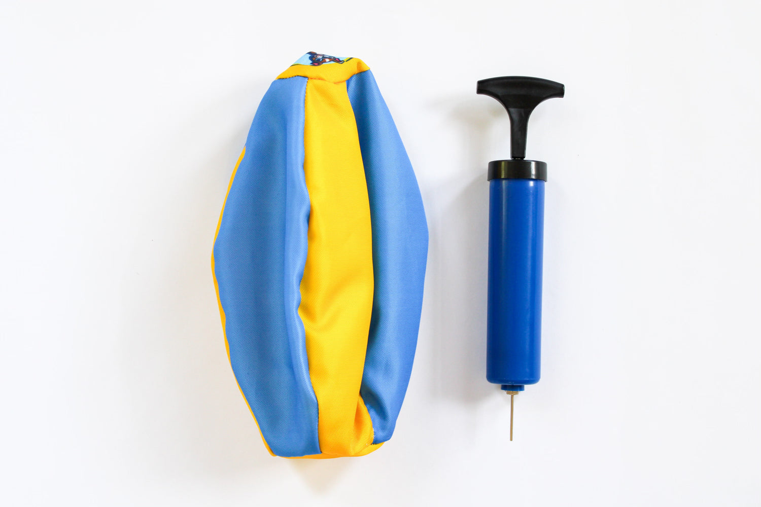 Deflated Bosty Ball next to included hand pump